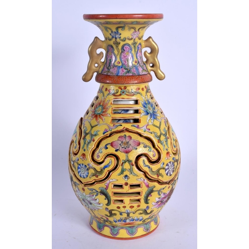 1981 - A CHINESE TWIN HANDLED FAMILLE ROSE RETICULATED VASE 20th Century, painted with floral sprays. 23 cm... 