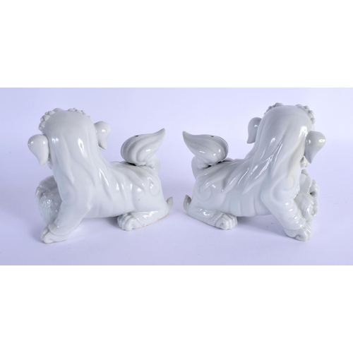 2025 - A PAIR OF 19TH CENTURY CHINESE PORCELAIN BUDDHISTIC LIONS modelled standing upon an orb and a young ... 