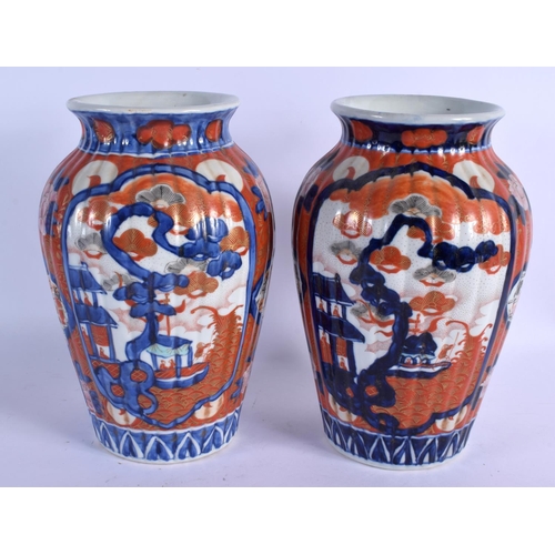 2062 - A PAIR OF 19TH CENTURY JAPANESE MEIJI PERIOD RIBBED VASES painted with landscapes. 26 cm high.