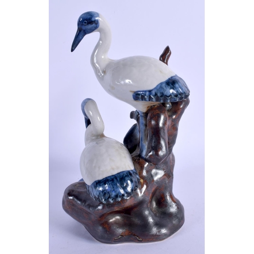 2064 - AN EARLY 20TH CENTURY JAPANESE MEIJI PERIOD STONEWARE GROUP formed with two birds. 23 cm high.