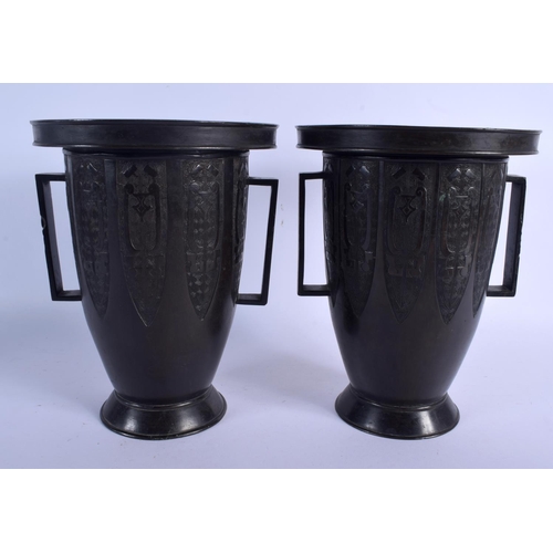 2069 - A 19TH CENTURY JAPANESE MEIJI PERIOD TWIN HANDLED BRONZE VASES of archaic form. 22 cm x 14 cm.