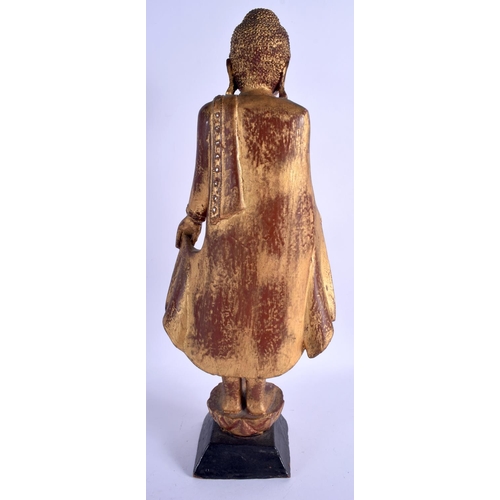 2093 - AN EARLY 20TH CENTURY SOUTH EAST ASIAN THAI GILTWOOD BUDDHA lacquered and jewelled. 44 cm high.