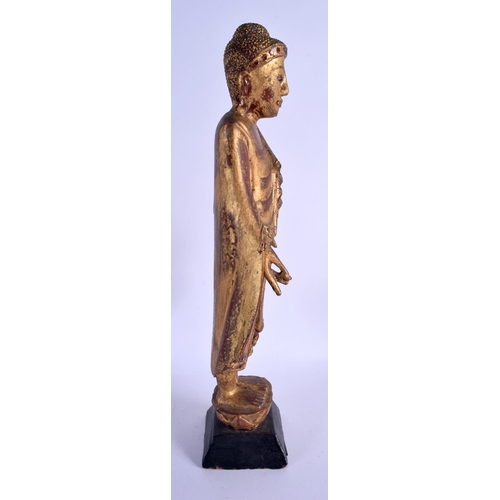 2093 - AN EARLY 20TH CENTURY SOUTH EAST ASIAN THAI GILTWOOD BUDDHA lacquered and jewelled. 44 cm high.