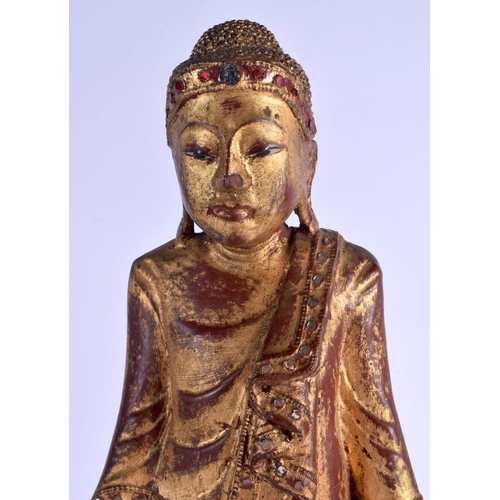 2093 - AN EARLY 20TH CENTURY SOUTH EAST ASIAN THAI GILTWOOD BUDDHA lacquered and jewelled. 44 cm high.