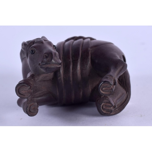 2132 - A JAPANESE CARVED BOXWOOD HORSE NETSUKE. 5 cm x 4 cm.