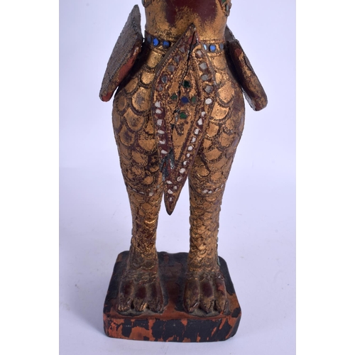 2150 - A SOUTH EAST ASIAN THAI GILTWOOD FIGURE OF A BUDDHISTIC DEITY modelled jewelled. 47 cm high.