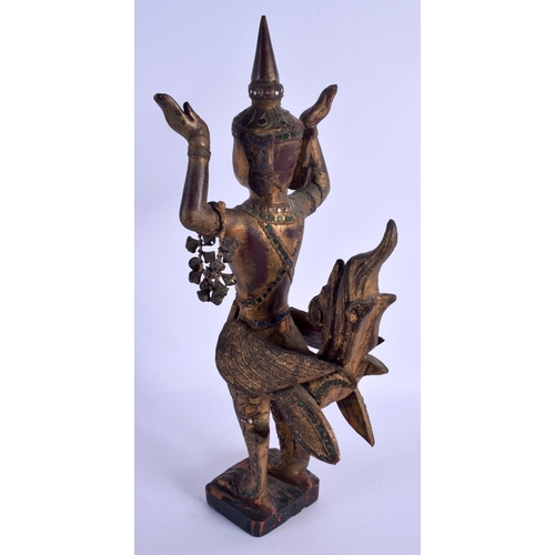 2150 - A SOUTH EAST ASIAN THAI GILTWOOD FIGURE OF A BUDDHISTIC DEITY modelled jewelled. 47 cm high.