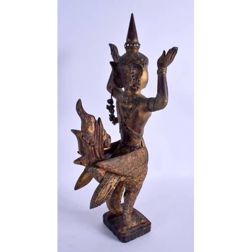 2150 - A SOUTH EAST ASIAN THAI GILTWOOD FIGURE OF A BUDDHISTIC DEITY modelled jewelled. 47 cm high.