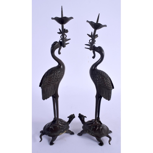 2167 - A PAIR OF 19TH CENTURY JAPANESE MEII PERIOD BRONZE CANDLESTICKS modelled as birds upon a beast. 21 c... 