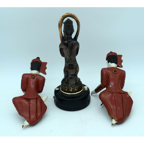 2500 - A vintage lighter and two wooden Thai figures (29cm)