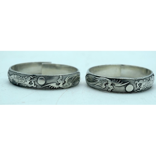 2527 - Two Chinese white metal embossed bracelets (2).