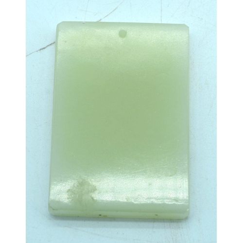 2556 - A small carved Chinese Jade tablet 7.5 x 5 cm.