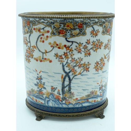 2569 - A large European glazed pot in a Chinese style decorated with foliage mounted on a bronze stand 29 x... 