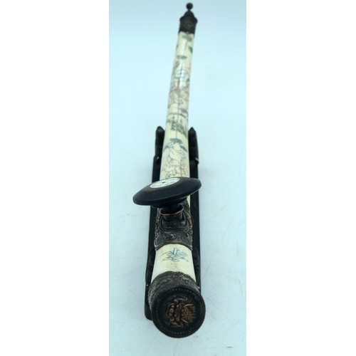 2570 - Chinese engraved bone opium pipe with a hardwood stand. 42cm.