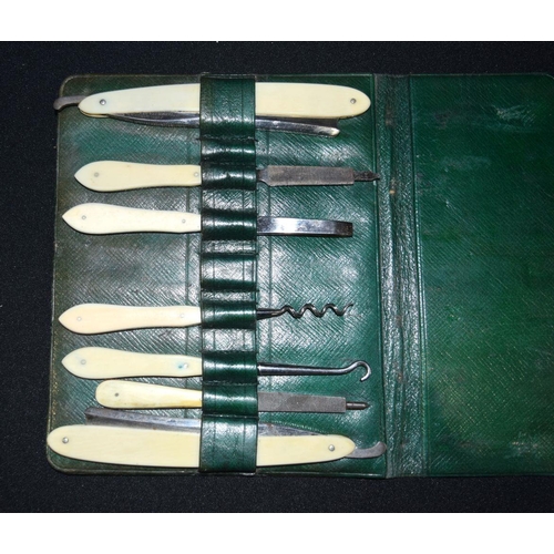 2573 - A vintage grooming set in green leather with folding mirror 37 x 18cm (3).