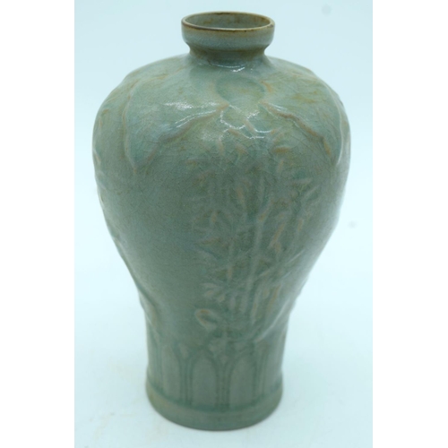 2603 - A Chinese Celadon Mei ping  vase  decorated with foliage in relief . 21cm.