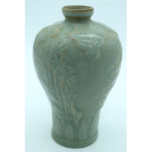 2603 - A Chinese Celadon Mei ping  vase  decorated with foliage in relief . 21cm.