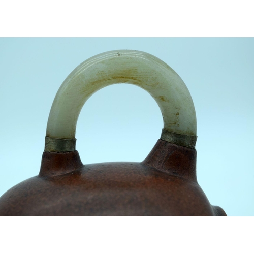 2607 - A Chinese Yixing tea pot with a mounted Jade handle and spout. 10 x 17cm.