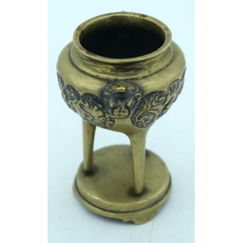 2608 - A Chinese Bronze tri pod censer embossed with a dragon pattern 13 x 10cm.