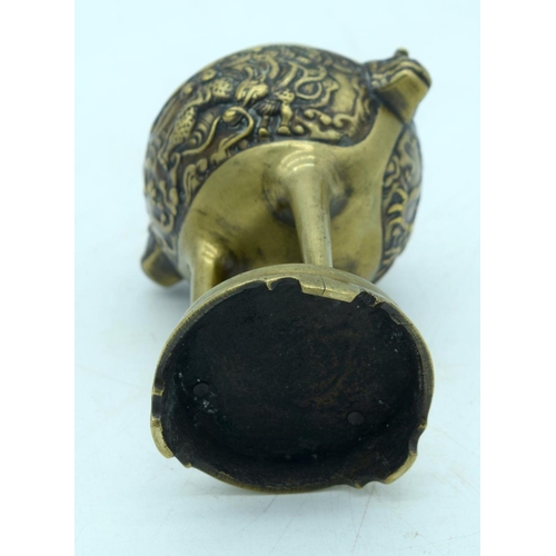 2608 - A Chinese Bronze tri pod censer embossed with a dragon pattern 13 x 10cm.