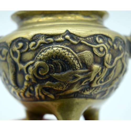 2608 - A Chinese Bronze tri pod censer embossed with a dragon pattern 13 x 10cm.