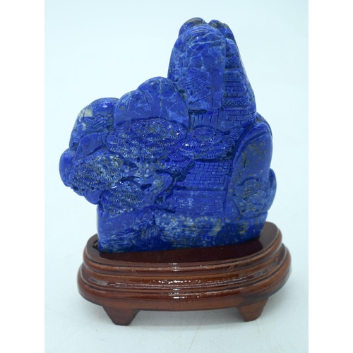 2610 - A carved Lapis Lazuli boulder mounted on a stand 17 x 13cm.