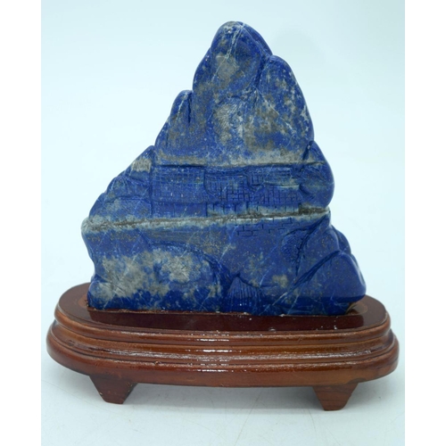 2611 - A carved Lapis Lazuli boulder mounted on a stand 19 x 16cm.