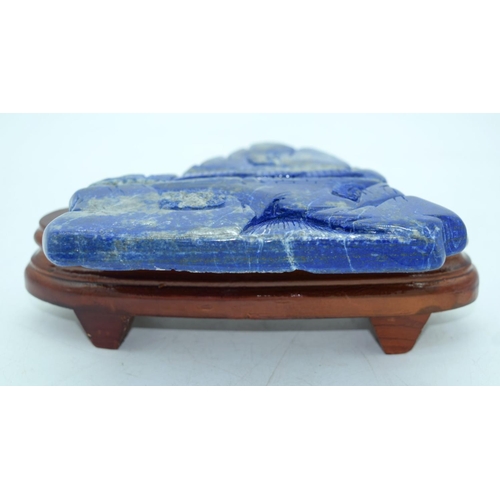 2611 - A carved Lapis Lazuli boulder mounted on a stand 19 x 16cm.