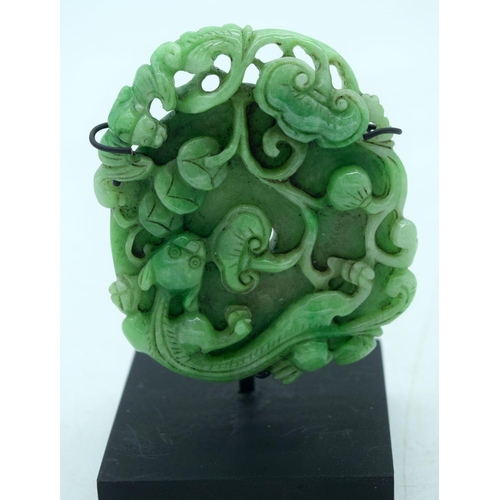 2613 - A Chinese carved Jade boulder on a stand 9 x 8cm.