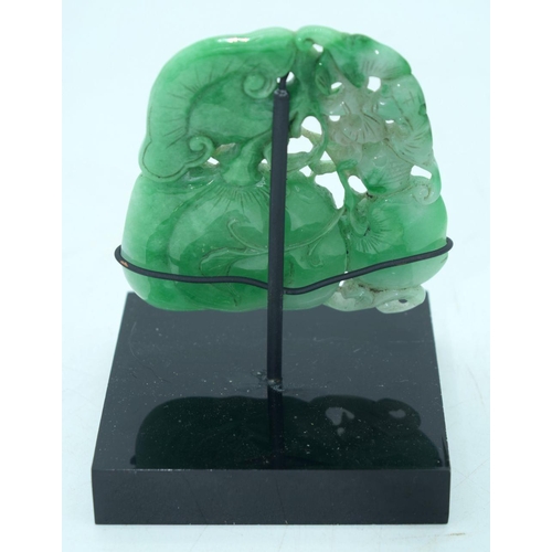 2614 - A Chinese carved Jade boulder on a stand 9 x 9cm.