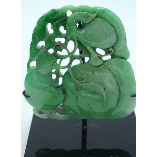 2614 - A Chinese carved Jade boulder on a stand 9 x 9cm.