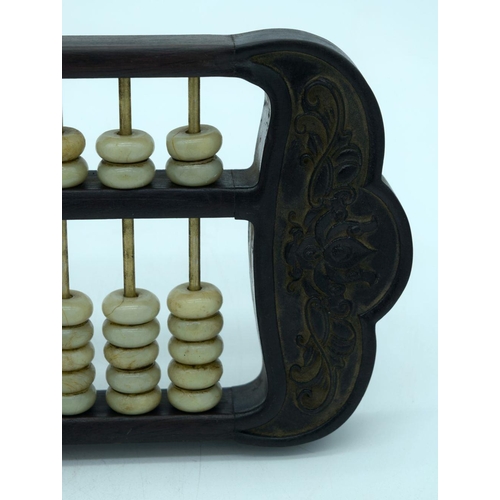 2618 - A Chinese hard wood framed Abacus with Jade counters. 42cm.