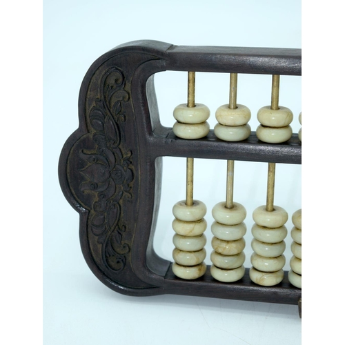 2618 - A Chinese hard wood framed Abacus with Jade counters. 42cm.