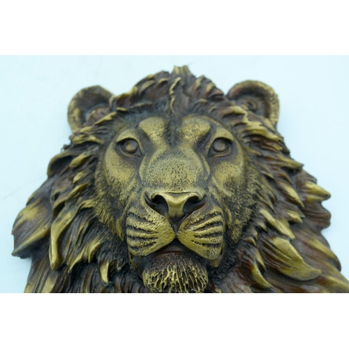 2623 - A Bronze lions head wall hanging .