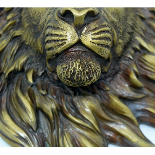 2623 - A Bronze lions head wall hanging .