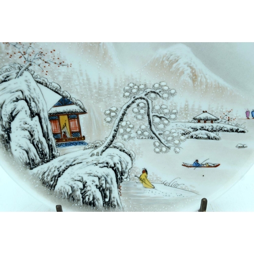 2624 - A Chinese plate celebrating 1973 decorated with a snowy landscape 23cm.