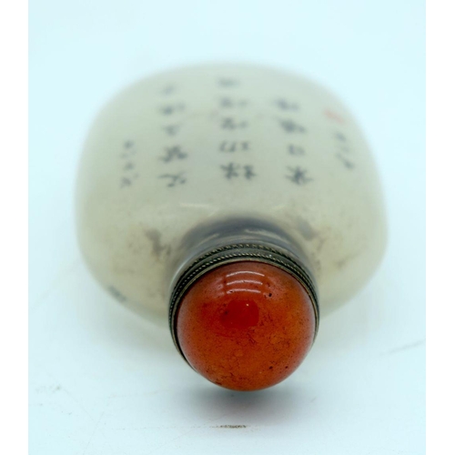 2629 - A Chinese snuff bottle decorated with calligraphy and a Chinese male. 9cm.