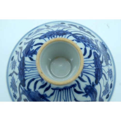 2640 - A Chinese blue and white stem cup decorated with fish. 16 x 10cm.