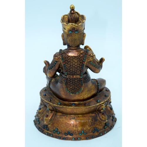 2648 - A bronze Chinese Tibetan Buddha with coloured bead inserts. 26cm.