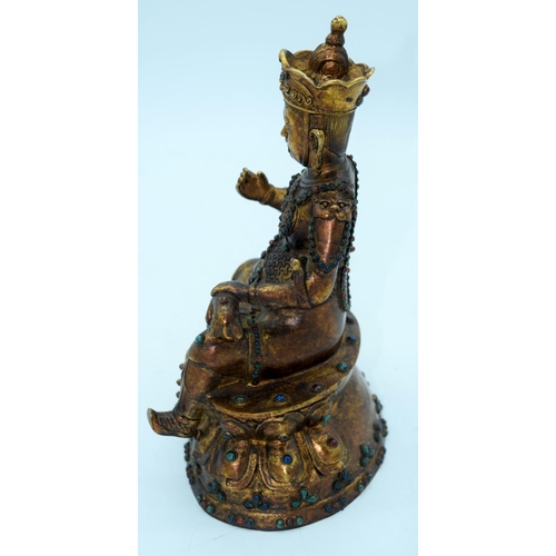 2648 - A bronze Chinese Tibetan Buddha with coloured bead inserts. 26cm.