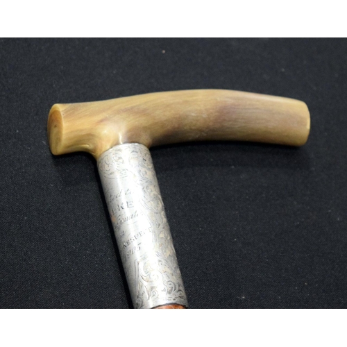 2652 - A Rhino horn handled walking stick with fine silver banding 92cm