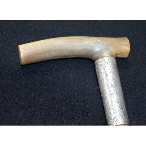 2652 - A Rhino horn handled walking stick with fine silver banding 92cm