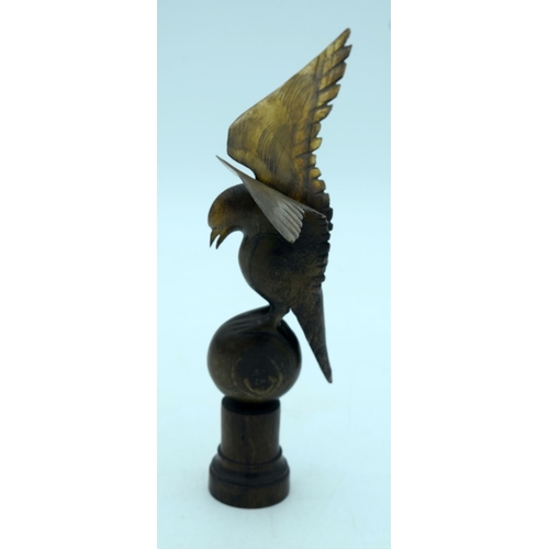 2655 - A  carved horn bird mounted on a wooden plinth .24cm .