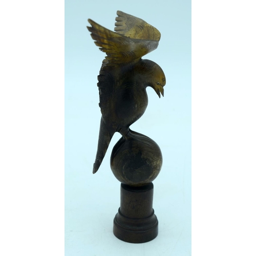 2655 - A  carved horn bird mounted on a wooden plinth .24cm .