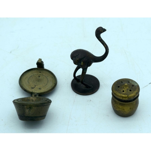 2657 - A small bronze set of graduated weights together with two other bronze items. 7cm (3)