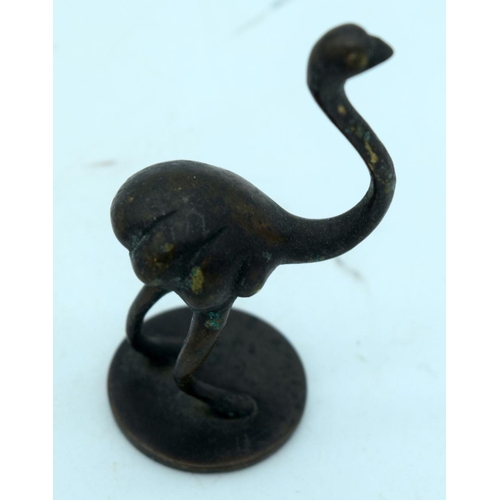 2657 - A small bronze set of graduated weights together with two other bronze items. 7cm (3)