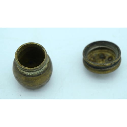 2657 - A small bronze set of graduated weights together with two other bronze items. 7cm (3)