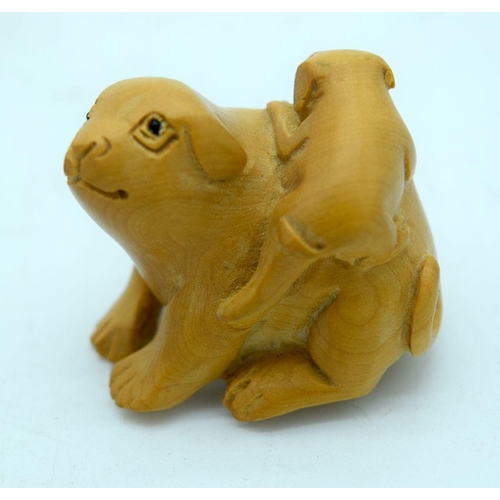 2658 - A carved wooden Netsuke inn the form of a dog and a carved wooden skull 4cm (2)