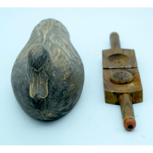 2661 - A vintage hand carved wooden decoy and a fruit press. 29cm (2).