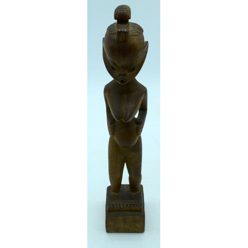 2663 - A carved wooden African  kneeling fertility  figure and another figure . 33 cm (2).